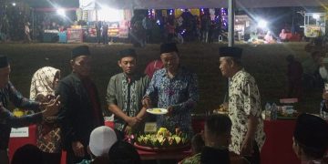 Desa Tanjung Jaya Genap Berusia 40 Tahun Kades Santoso Potong Tumpeng